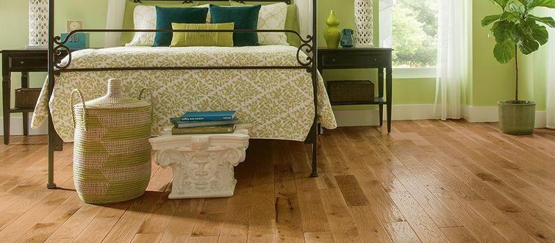 Light brown shiny hardwood floor in a bedroom