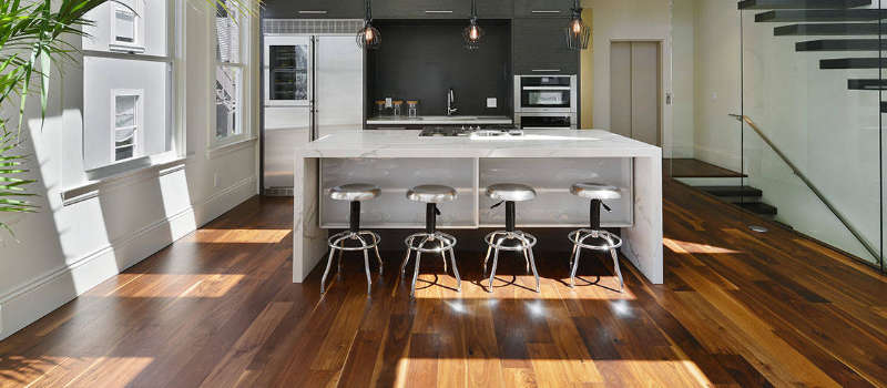 brown solid wood flooring in a modern kitchen