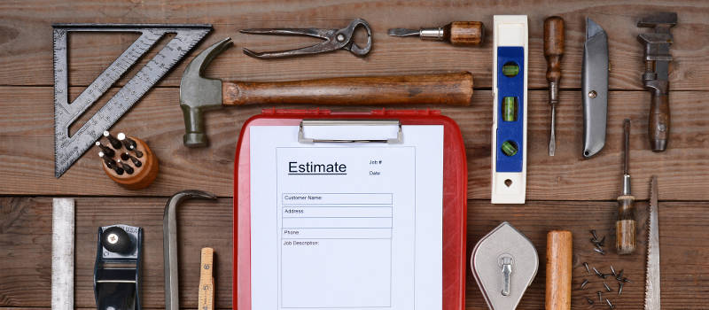 contractor's estimate page with tools on a wood surface