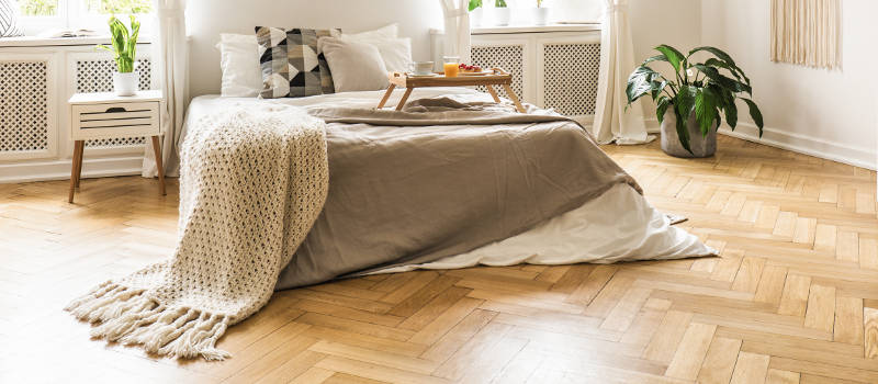 contemporary bedroom with wood parquet floor