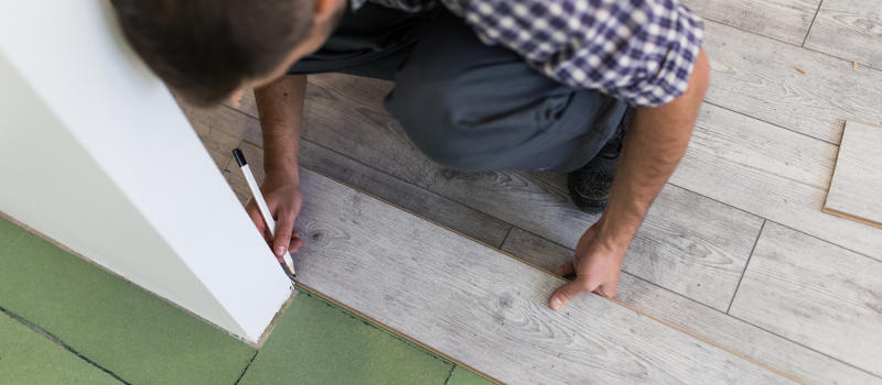 Man installing laminate floor planks