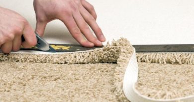 hands cutting carpet to size for installation